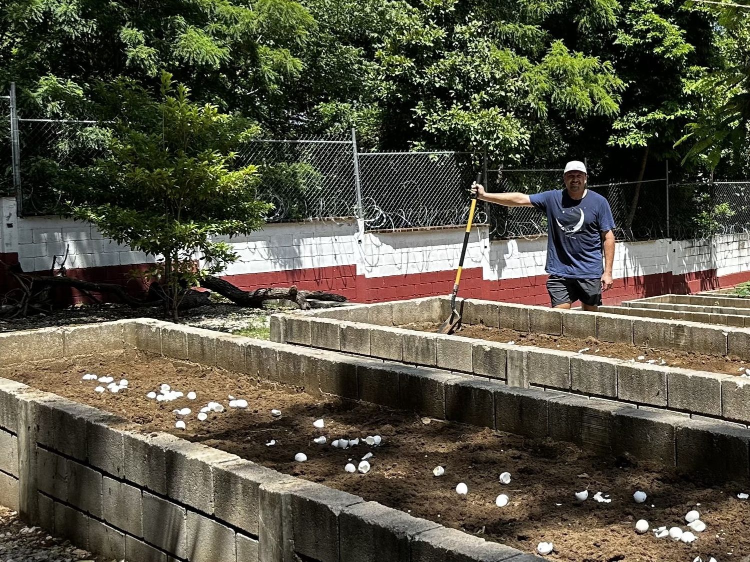 Scott Kimball beside newly built raised garden beds at a children's home in Chiapas